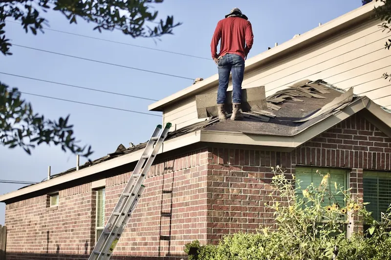 Professional roofer working on a residential roof in Astrodome